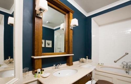 a bathroom with a sink and a mirror at The Marine in Whitstable