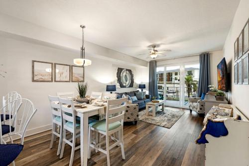 a dining room and living room with a table and chairs at Calypso 3 New Relax Unwind Luxury PCB next to Pier Park 3 Bed 2 Bath Pool Hot Tub Tikki bar in Panama City Beach
