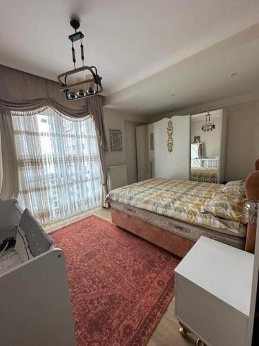 a bedroom with a large bed and a large window at شقة باطلالة على البحر in Istanbul