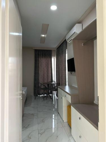 a room with a kitchen and a dining room at Summer Gate Hotel in Ksamil