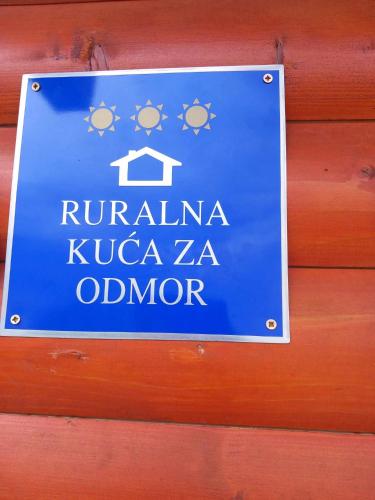 a blue sign hanging on a wooden wall at Resort Dudukovic 2 in Slunj