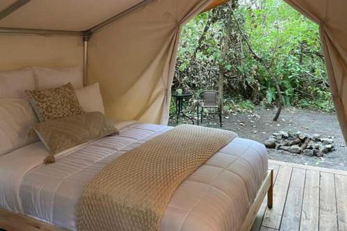 a bedroom with a bed in a tent at The Fox Den in Delta