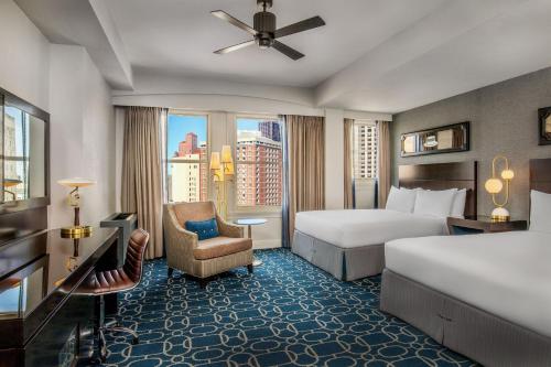 a hotel room with a bed and a chair at Hotel Adagio, Autograph Collection in San Francisco