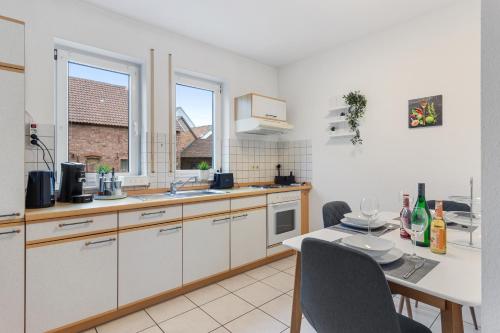 a kitchen with a table and a sink and a counter at WINETIME - für 3 - nähe Madenburg - Burg Landeck in Eschbach
