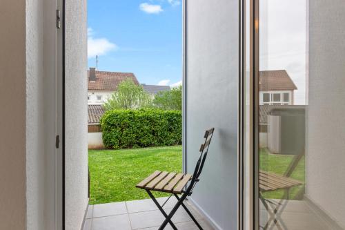 a chair sitting on a balcony outside a door at WINETIME - für 3 - nähe Madenburg - Burg Landeck in Eschbach