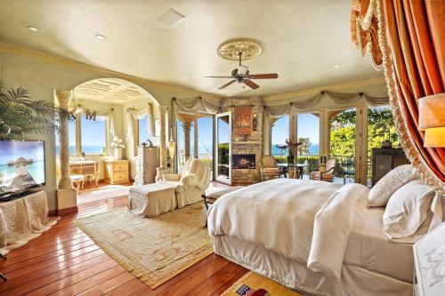 a bedroom with a large bed and a living room at Malibu by the Sea - 5-STARS! in Solromar