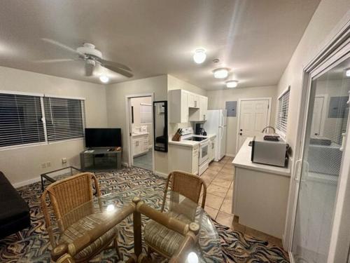 a living room with a table and chairs and a kitchen at Waimanalo Beach Cottages in Waimanalo