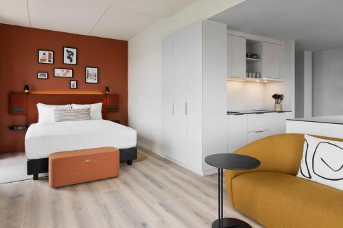 a bedroom with a bed and a couch at Residence Inn by Marriott Copenhagen Nordhavn in Copenhagen