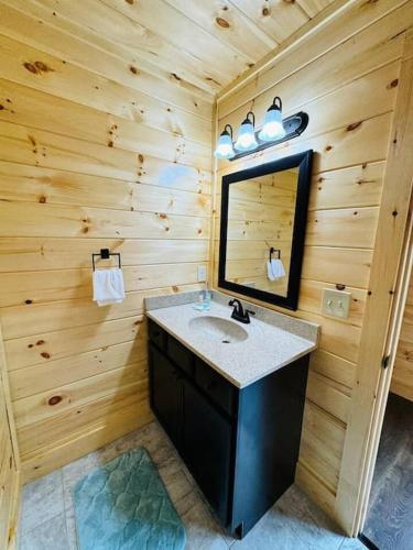 a bathroom with a sink and a mirror at New! Indoor Pool/PS 5/Hot tub/Parkway in Pigeon Forge
