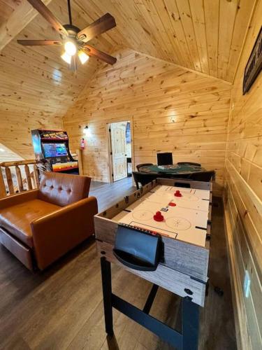 a room with a ping pong table in a cabin at New! Indoor Pool/PS 5/Hot tub/Parkway in Pigeon Forge