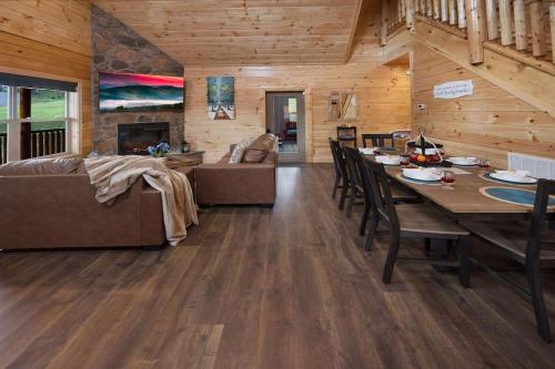 a living room with a table and a couch at New! Indoor Pool/PS 5/Hot tub/Parkway in Pigeon Forge