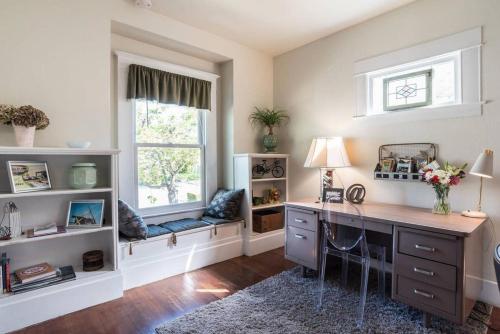 a home office with a desk and a window at Retro Bungalow in Santa Rosa