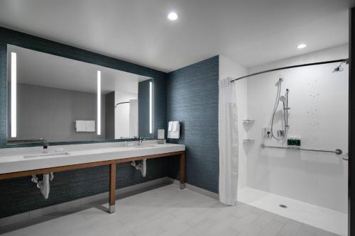 a bathroom with a sink and a shower at Courtyard by Marriott Delray Beach in Delray Beach