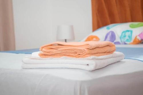 a stack of towels sitting on top of a table at LES RÉSIDENCES ROYAL LUXE 3a in Cancino