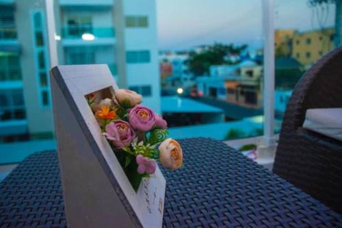 a bouquet of flowers sitting on top of a table at LES RÉSIDENCES ROYAL LUXE 3a in Cancino