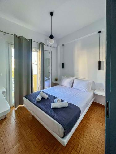 a bedroom with a large bed with towels on it at Aeolian Breeze 2 in Tinos