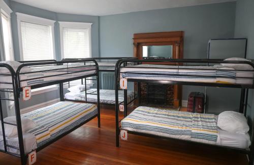 a room with four bunk beds with a mirror at Wrigley Hostel - Chicago in Chicago