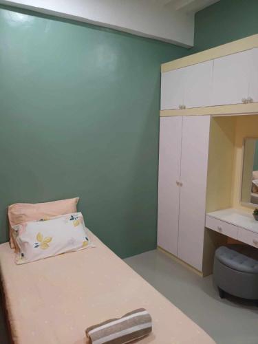 a small room with a bed and a mirror at ConVill Residences in General Santos