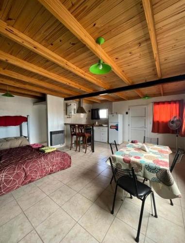 a bedroom with a bed and a table in a room at Depto Ruta 3 in Trelew