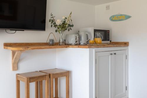a kitchen with a counter with a tv on it at Little Highfield in Kingsbridge
