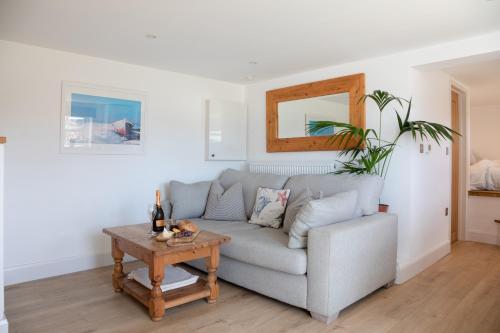 a living room with a couch and a table at Little Highfield in Kingsbridge