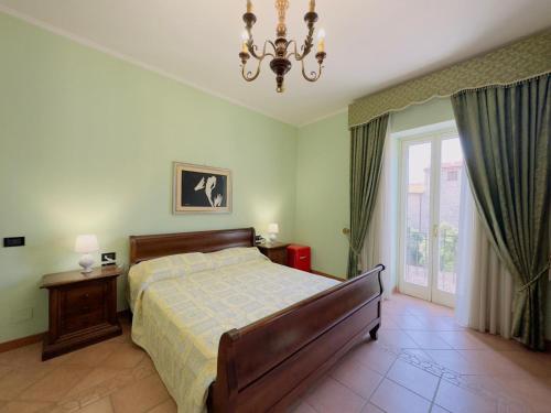 a bedroom with a bed and a chandelier at CASA PEPE - Fondi Vertice Rooms in Fondi