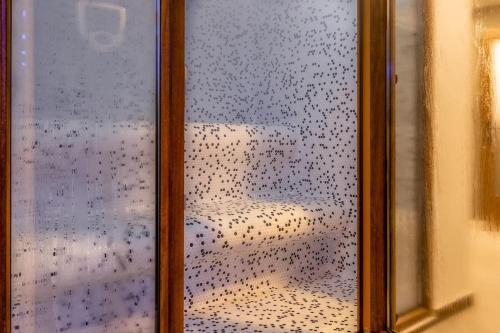 a glass window with a view of a couch at Luxurious Villa in Prevalla in Prevallë