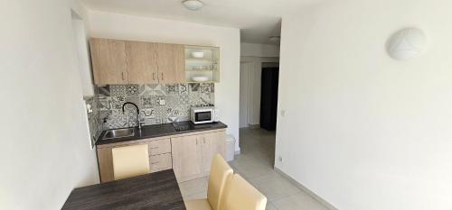 a kitchen with a sink and a microwave at Apartment Buco in Starigrad