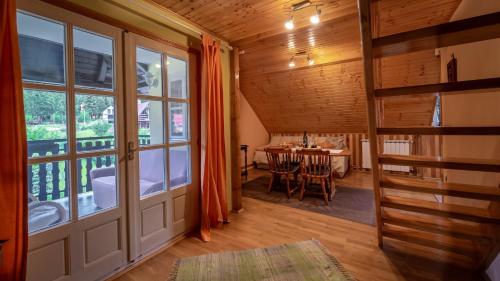 a room with a large window and a table with chairs at Apartments with parking space Mrkopalj, Gorski kotar - 19212 in Mrkopalj