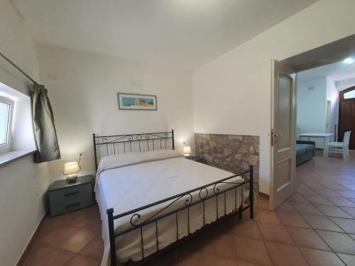 a bedroom with a bed and a hallway with a table at CASA PEPE - Fondi Vertice Rooms in Fondi