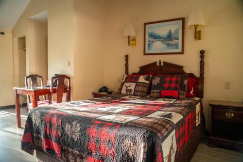 a bedroom with a bed and a table with a chair at Dean Creek Resort in Redway