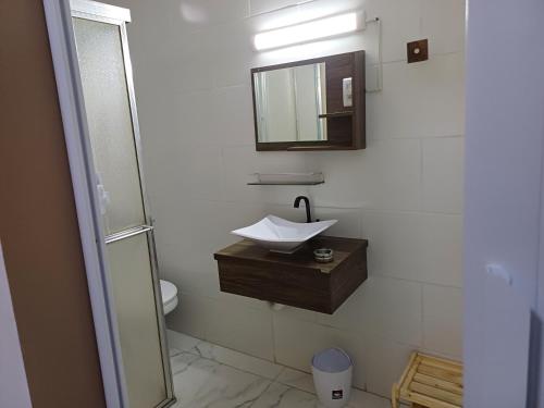 a bathroom with a sink and a mirror at #paradise suíte Tatuapé Executiva #4 in São Paulo
