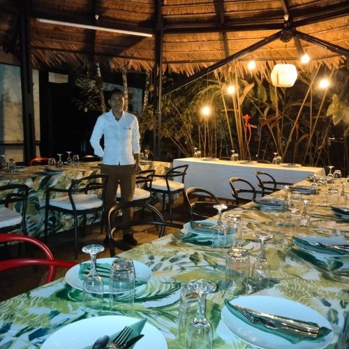 a man standing in front of a table in a restaurant at Hotel Amazon Bed And Breakfast in Leticia