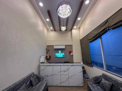 a lobby with a bar and a tv and a window at Hotel Leesha Residency in Kalyan