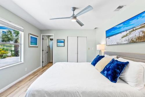 a bedroom with a bed and a ceiling fan at Private Heated Pool - 100 Steps to Beach Access - 5-min walk to Siesta Key Village in Siesta Key