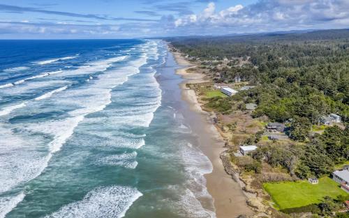 an aerial view of the shoreline of a beach at The Sea Anemone - Meredith Lodging in Yachats
