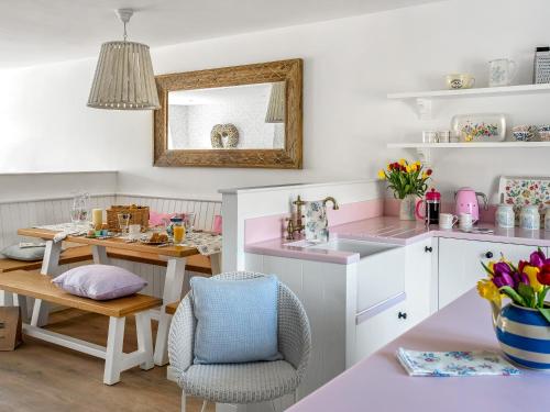a kitchen with a table and a dining room at The Dormouse -uk46926 in Newby Bridge