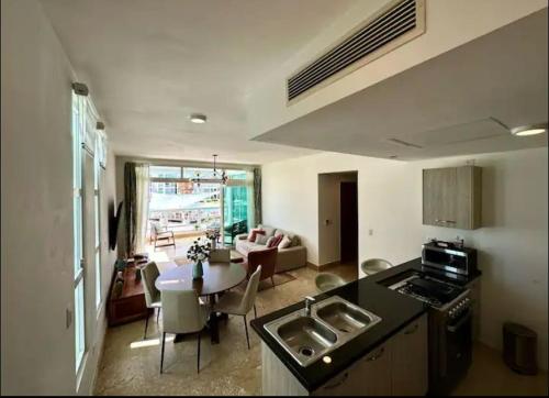 a kitchen and living room with a table and a kitchen and a living room at Playa Nueva Romana Royal Vip in San Pedro de Macorís