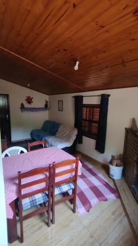 salon ze stołem i łóżkiem w obiekcie Casa da Cíntia w mieście Visconde De Maua