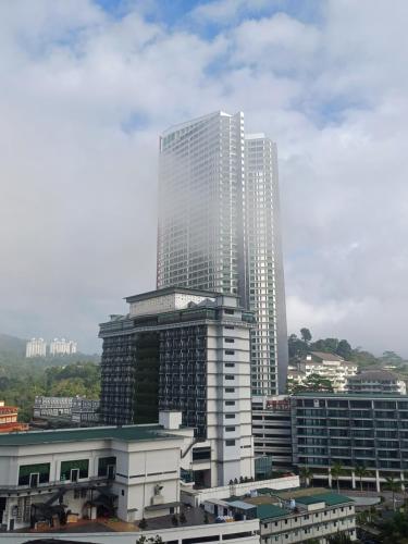 a tall white building in a city with buildings at Windmill Upon Hills Genting Highland by Sweet Memory in Genting Highlands