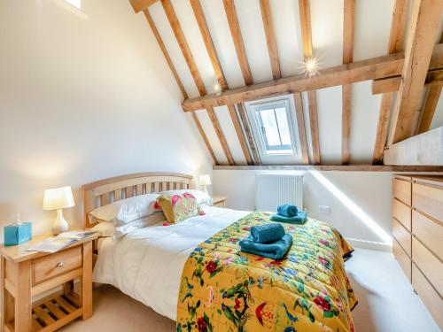 a bedroom with a bed and a desk and a table at Chapel Barn - Uk46738 in Shapwick