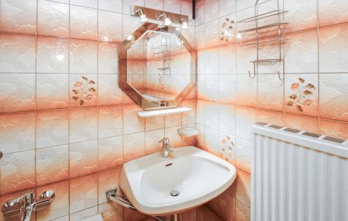 a white sink in a bathroom with pink tiles at Ferienhaus In Idylle St, Peter in Inneraigen