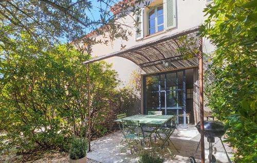 a patio with a table in front of a house at Beautiful Home In Saint-Laurent-De-La-Cabrerisse in Saint-Laurent-de-la-Cabrerisse