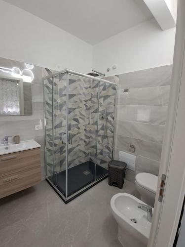 a bathroom with a shower and a toilet and a sink at Rovelli House in Foggia