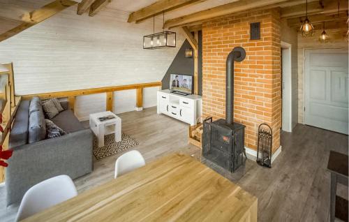 a living room with a couch and a wood stove at Pet Friendly Apartment In Sorkwity in Sorkwity