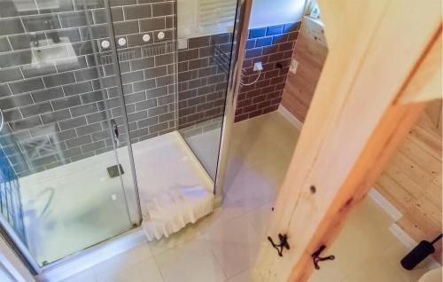 a bathroom with a shower with a glass door at 2 Bedroom Stunning Apartment In Sorkwity in Sorkwity