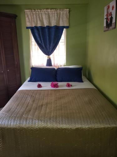 a bed with pink flowers on it in a bedroom at Sk SHaven #2 in Castries