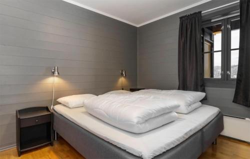 a large white bed in a room with a window at Nice Apartment In Hemsedal With House A Mountain View in Hemsedal