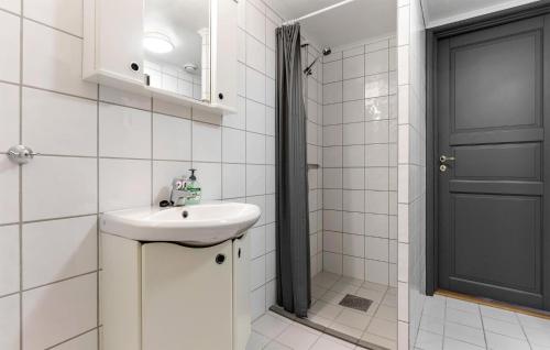 a white bathroom with a sink and a black door at Nice Apartment In Hemsedal With House A Mountain View in Hemsedal