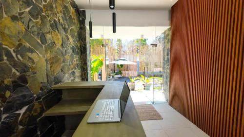 a laptop computer sitting on a bench in a room at Go Boutique Inn in Puerto Princesa City